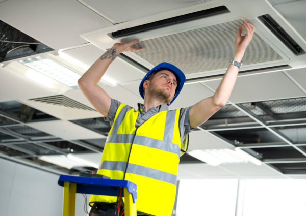 Engineer working on the heating, ventilation & air conditioning (hvac) system of a commercial building